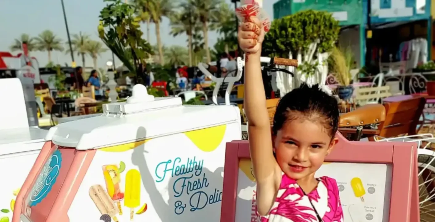 A selection of colorful fruit pops served in Dubai, capturing the joy of families choosing refreshing alternatives to ice cream.