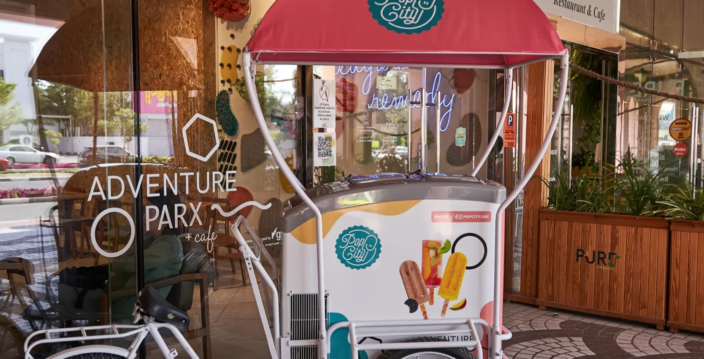 Pop City event cart surrounded by colorful popsicles, with decorations for a child's birthday party in Dubai.